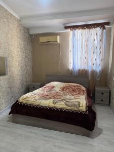 a bedroom with a bed in a room with a window at Full moon in Yerevan