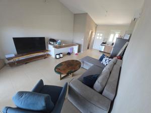 a living room with a couch and a table at Vlad's Apartments in Larisa
