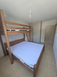 a bedroom with two bunk beds and a closet at Vlad's Apartments in Larisa