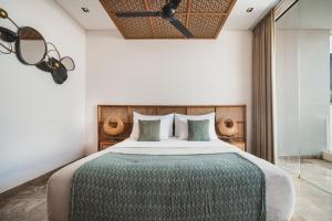 a bedroom with a large bed and a ceiling at Eight Palms Villa Seminyak by Ini Vie Hospitality in Seminyak +59 photos
