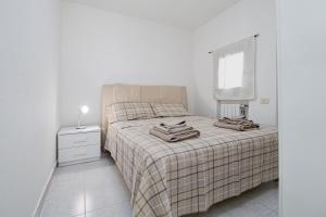 a bedroom with a bed with two towels on it at Villa Rosa in Olbia +13 photos