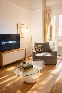 a living room with a tv and a coffee table at MARY'S HOUSE The lux terrace in Tripoli