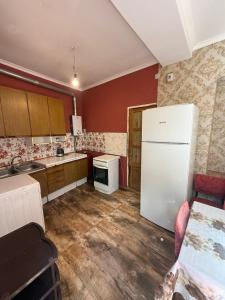 a kitchen with a white refrigerator and a stove at Full moon in Yerevan