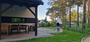 a gazebo with a grill in a yard at Cudodomek SPA Loft koło Ełku in Ełk