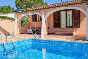 a villa with a swimming pool and a house at Villa Rosa in Olbia