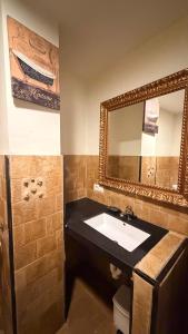 a bathroom with a sink and a mirror at Los Quejigares in Terradillos de Sedano +37 photos