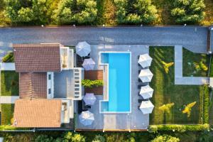 an aerial view of a house with a swimming pool at Assos Luxury Villas in Pefkochori