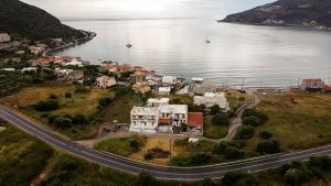 an aerial view of a house next to a road at MANI HOLIDAYS Rooms in Neo Itilo