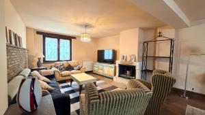 a living room with a couch and a fireplace at Los Quejigares in Terradillos de Sedano