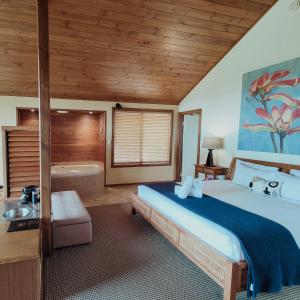 a bedroom with a large bed and a bath tub at Denmark Scenic Tourist Park in Denmark +104 photos