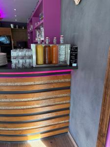 a bar with a row of bottles on a counter at Das Alpenglühn Hotel & Restaurant in Krün +23 photos
