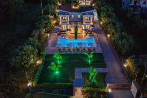 an overhead view of a house with a swimming pool at night at Assos Luxury Villas in Pefkochori