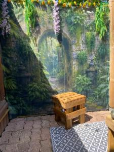 a wall with a bench and a mural at Au Pied de Troncais in Coust