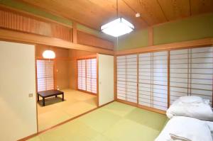 a room with two beds and a table in it at Sunrise Resort Aji in Takamatsu