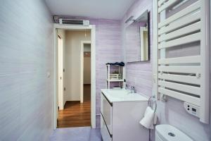 a bathroom with a sink and a toilet at The Clock Tower Apartment in Jaén