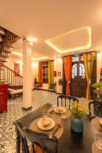 a dining room with a table and chairs at Bao An Home old Town in Hoi An