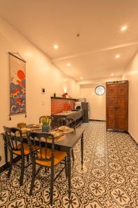 a dining room with a table and chairs at Bao An Home old Town in Hoi An +100 photos