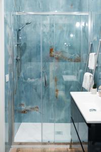 a shower with a glass door in a bathroom at Harmonia Rooms by Italy Home Experience in Civitavecchia +51 photos