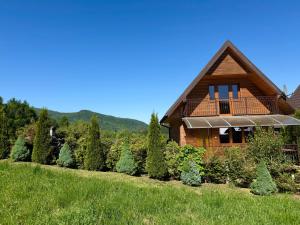 a house with a solarium on the side of it at Agroturystyka Jeleni Skok in Cisna
