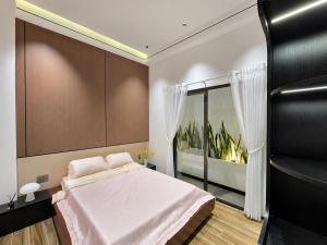a bedroom with a large bed and a window at MONO HAUS Villa Danang in Danang +35 photos