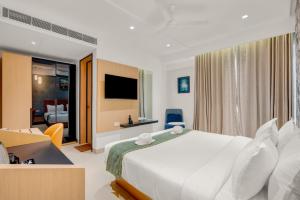 a hotel room with a bed and a television at Hotel Cachet in Coimbatore