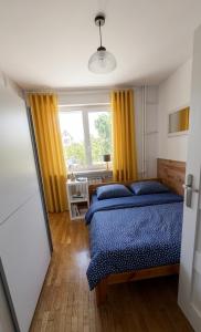 a bedroom with a bed and a window at Apartamenty W Domu in Białystok