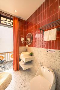 a bathroom with a toilet and a sink at Bao An Home old Town in Hoi An