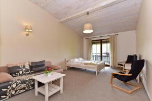 a living room with a couch and a bed at Luokesų Dvaro sodyba in Ažuluokesa +90 photos