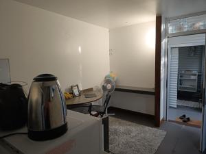 a kitchen with a tea kettle on top of a refrigerator at Studio à Tamaon - Malima Lodge in Pouembout