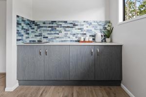 a kitchen with a sink and a counter at Rainforest Escape with Pool & Mountain Views in Caravonica