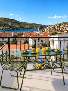 a table and chairs on a balcony with a view at 3-bedroom Sea View Home with Private Parking in Mokošica