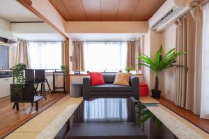 a living room with a couch and a table at REJ Reflet Ebisu in Tokyo