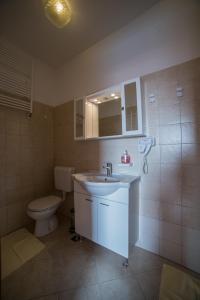 a bathroom with a sink and a toilet at Studio Apartman Rovinj in Rovinj +18 photos