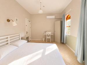 a bedroom with a white bed and a window at Sea Salt Inn in Kemer