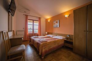 a hotel room with a bed and a window at Studio Apartman Rovinj in Rovinj