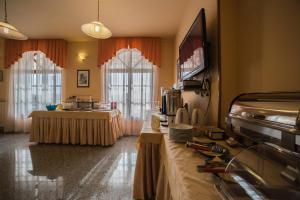 a living room with a table and a television at Studio Apartman Rovinj in Rovinj