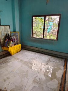 an empty room with a window and a tile floor at Pranusree Holiday Home in kolkata +24 photos