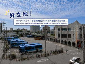a view of a parking lot with a bus at Portside Stay 石垣島 離島ターミナル徒歩3分 バスターミナル前 室内リニューアル in Ishigaki Island