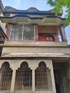a building with barred windows on the front of it at Pranusree Holiday Home in kolkata