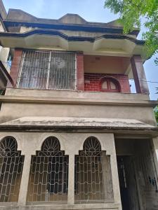 a building with iron gates on the front of it at Pranusree Holiday Home in kolkata