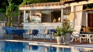 a patio with chairs and a table and a pool at B&B Sole e Luna in Palermo