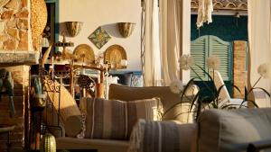 a living room with couches and chairs and flowers at B&B Sole e Luna in Palermo