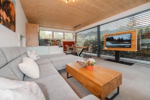a living room with a couch and a coffee table at Appartementhaus Anna in Leogang