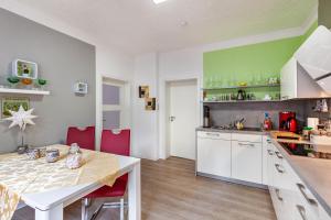 a kitchen with a table and a dining room at Ferienwohnung Waldglück in Lauchhammer