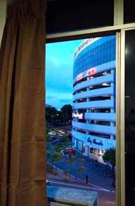 a view of a building from a window at SC Lodging Sinsuran Complex in Kota Kinabalu