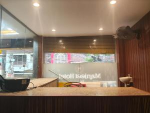 a kitchen with a counter top and a window at Manjeet Hotel & Restaurant in Ballia
