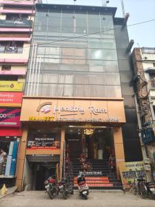 a store with motorcycles parked in front of a building at Manjeet Hotel & Restaurant in Ballia