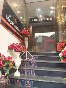 a window of a store with vases and flowers at Manjeet Hotel & Restaurant in Ballia