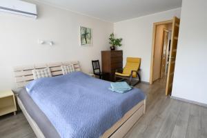 a bedroom with a bed and a desk and a chair at Algirdo Apartments, Self Check-in, Free Private Parking in Vilnius
