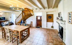 a living room with a table and a fireplace at Cottage À La Campagne in Mérigny